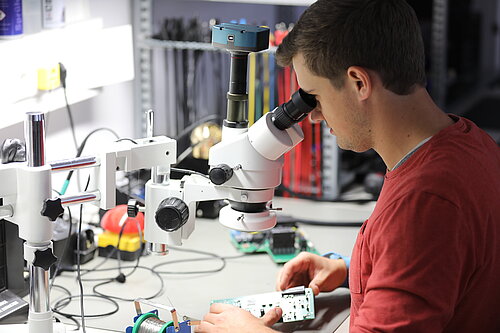 Testing an electronic assembly under the microscope for possible soldering defects. (Photo: BURGER ENGINEERING GmbH & Co. KG). BURGER ENGINEERING Testing assembly